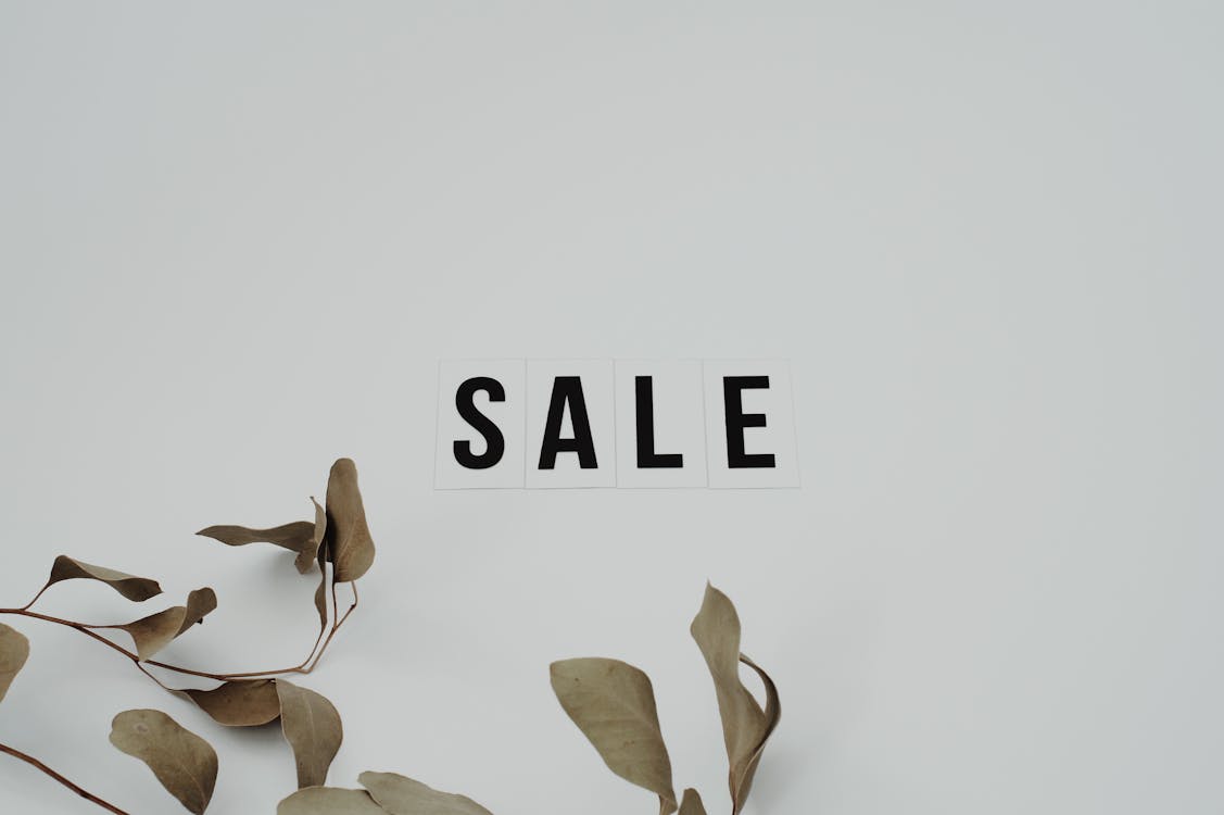 Free Word Sale on White Surface Stock Photo