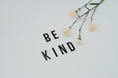 Be Kind Lettering on White Surface