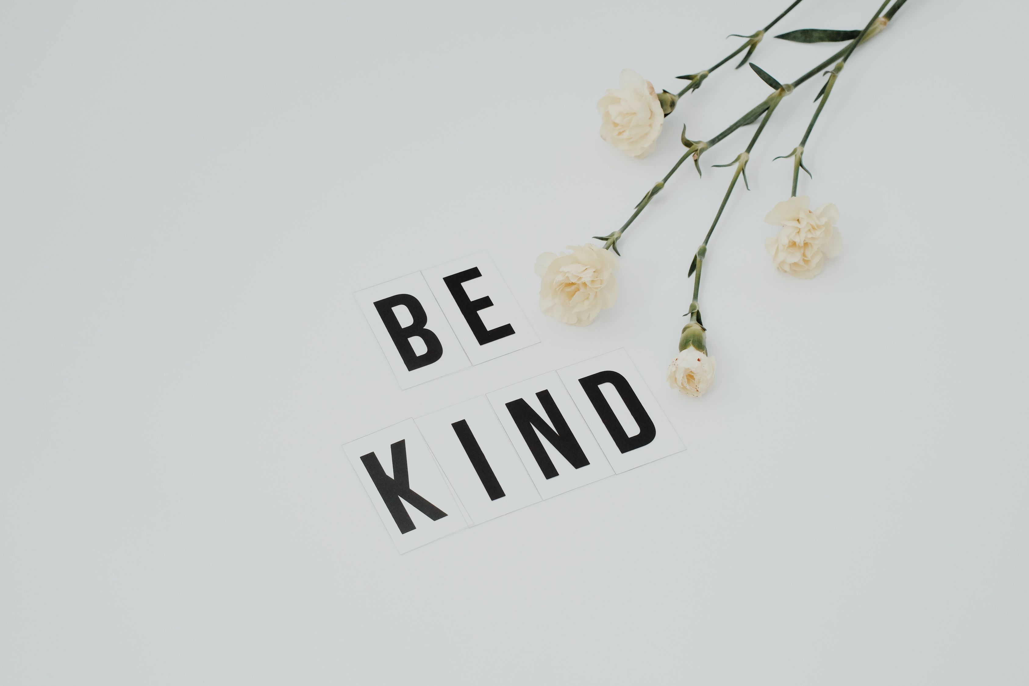 Be Kind Lettering on White Surface · Free Stock Photo