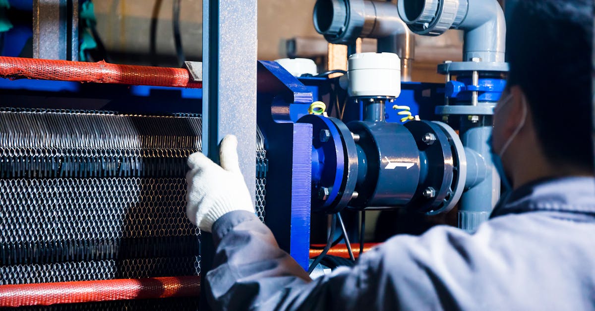 A Person Working with Industrial Machinery · Free Stock Photo