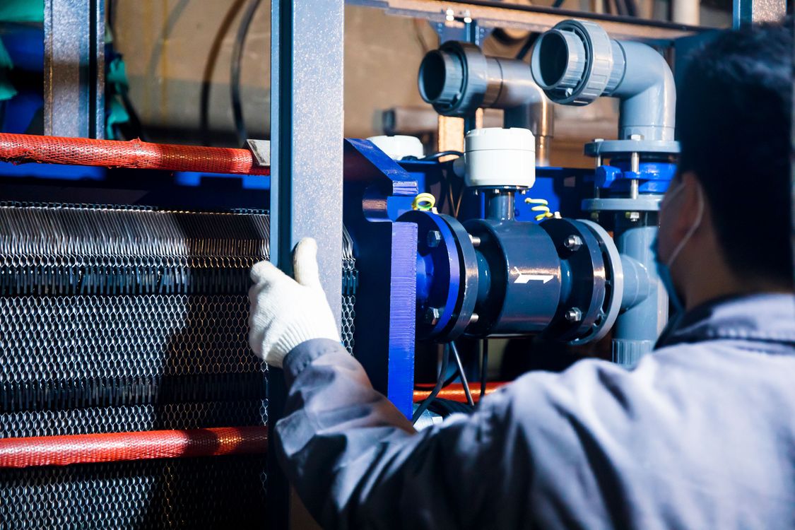 Industrial worker inspecting piping and process equipment