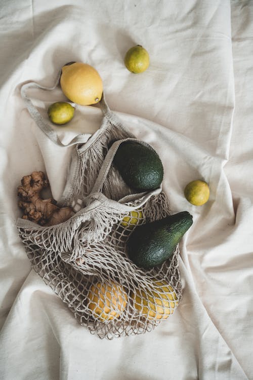 Free Yellow Round Fruits on White Textile Stock Photo