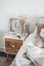 Brown Wooden Drawer Chest Beside White Bed