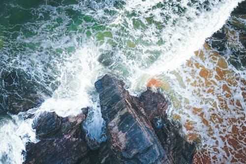 Stormy sea waving near rocky shore