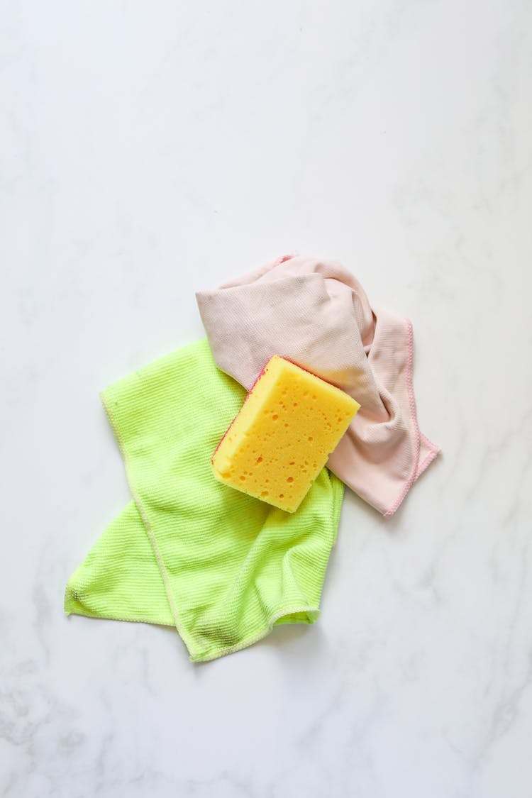 A Yellow Sponge Over Cleaning Cloth