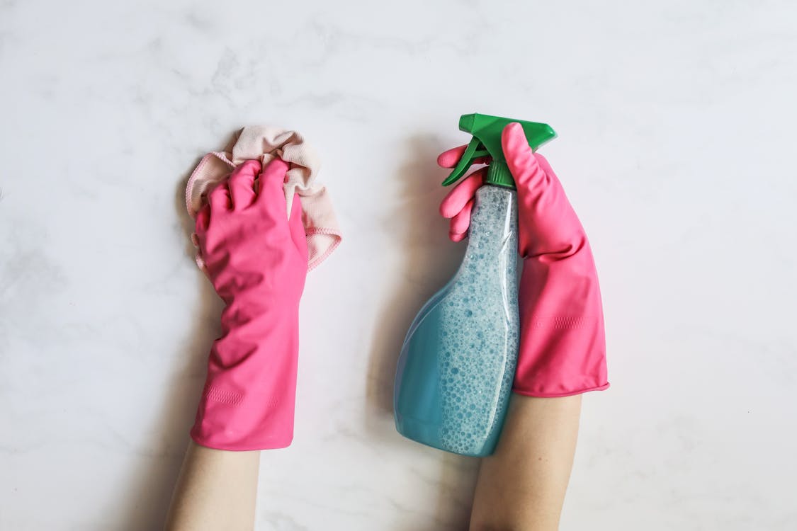 Free A Person Cleaning Using Cleaning Products Stock Photo