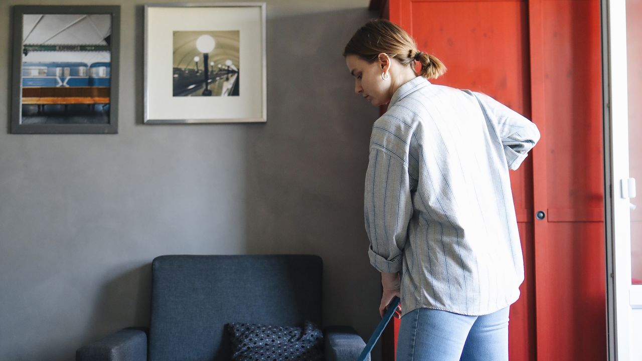 Short evening home reset routine Person cleaning a living room as part of a short daily home reset