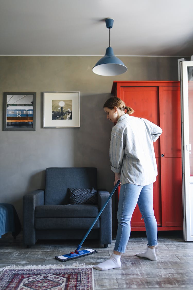 A Woman Mopping The Floor