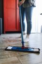Person in Blue Denim Jeans and Black Shoes Standing on Red and Blue Kick Scooter