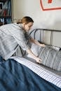 A Woman Fixing the Bed