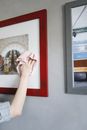 Person Holding White and Red Wall