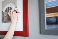 Person Holding White Textile Near Brown Wooden Framed Glass Window