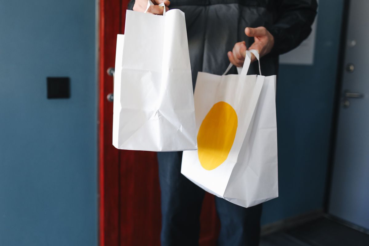 Printed paper bags with a bold yellow sun graphic for Copperline Coffee