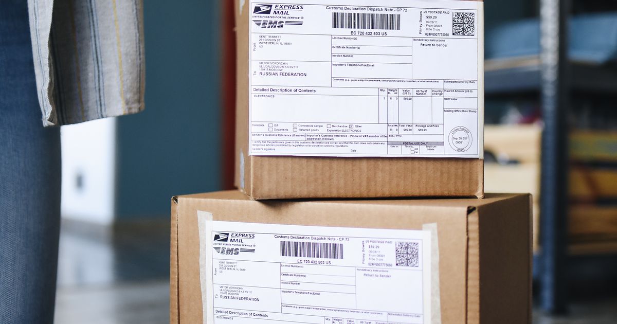 A stack of brown cardboard boxes with shipping labels.