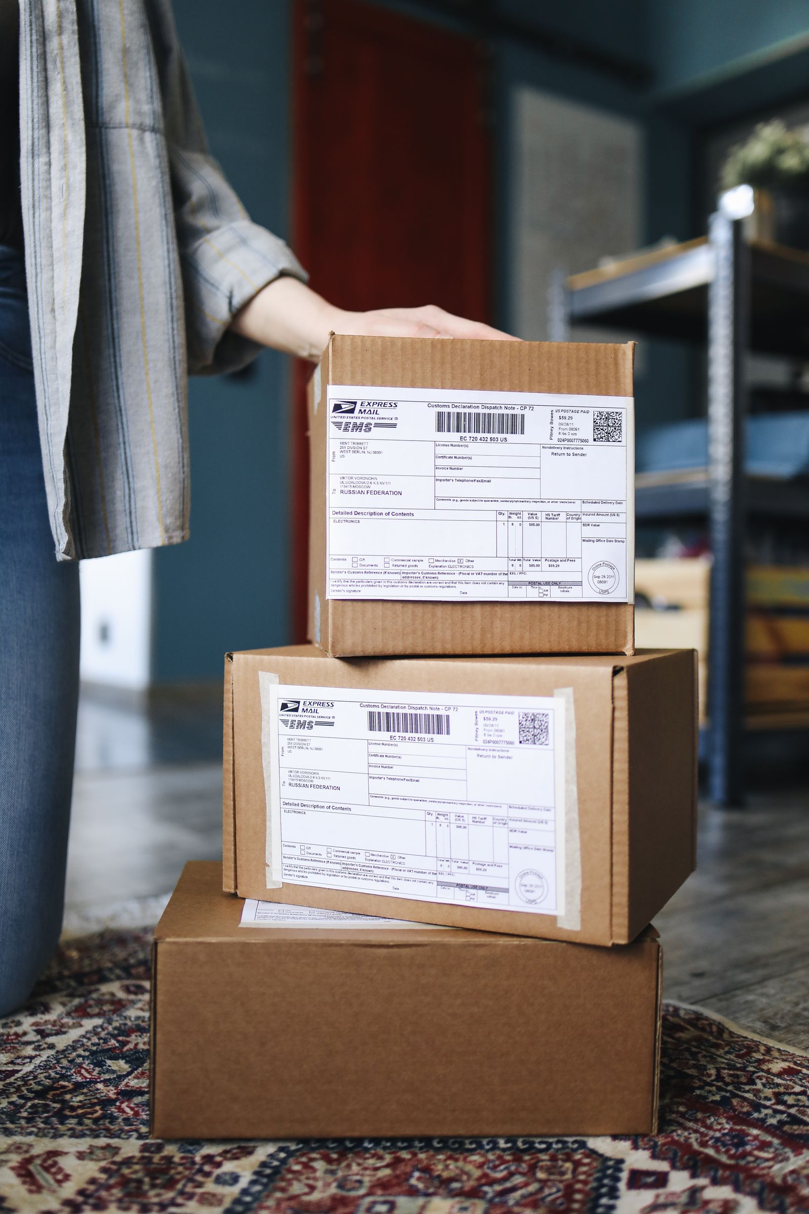 A stack of brown cardboard shipping boxes with labels, ready for delivery.