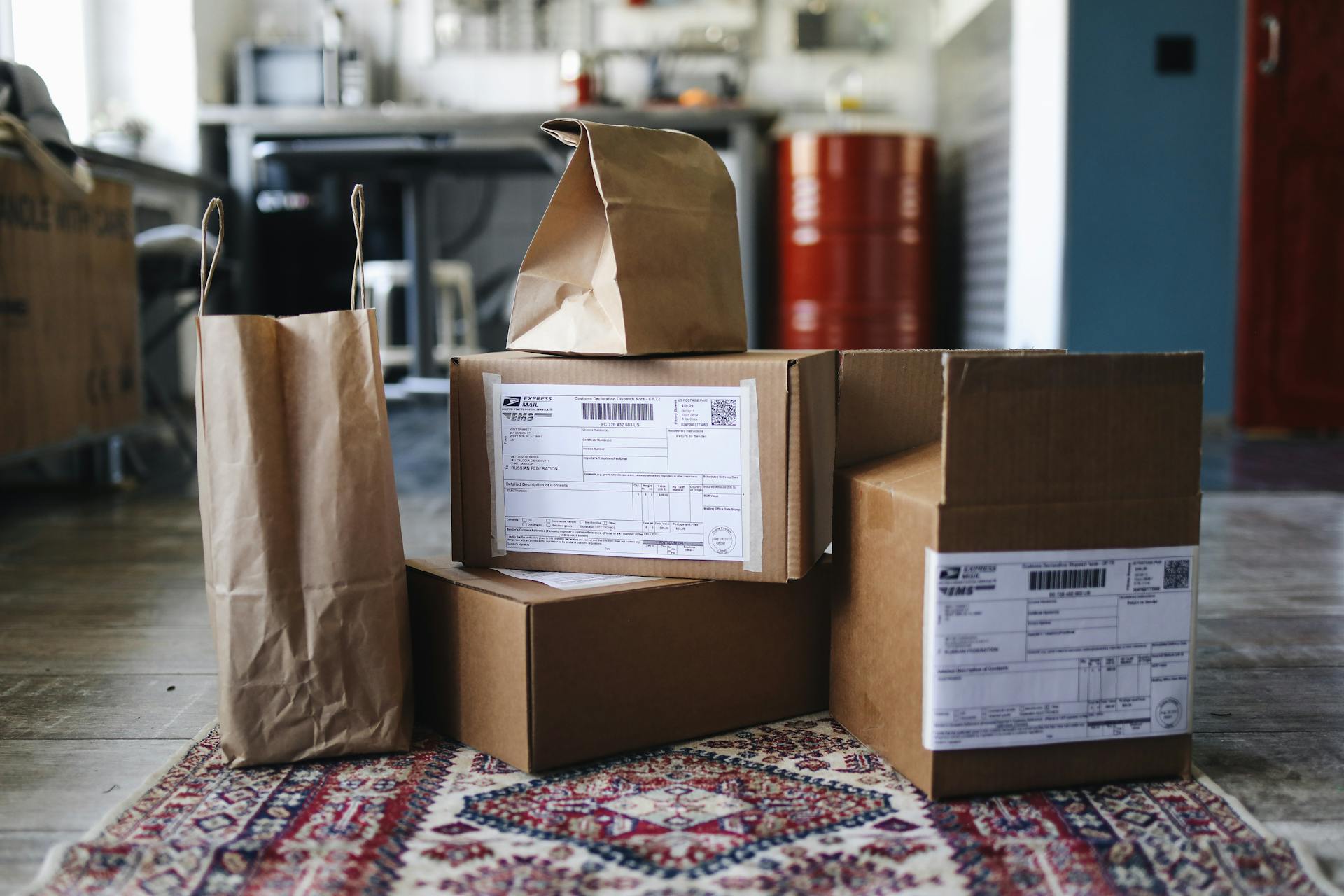 Cardboard Boxes and Paper Bags on a Rug