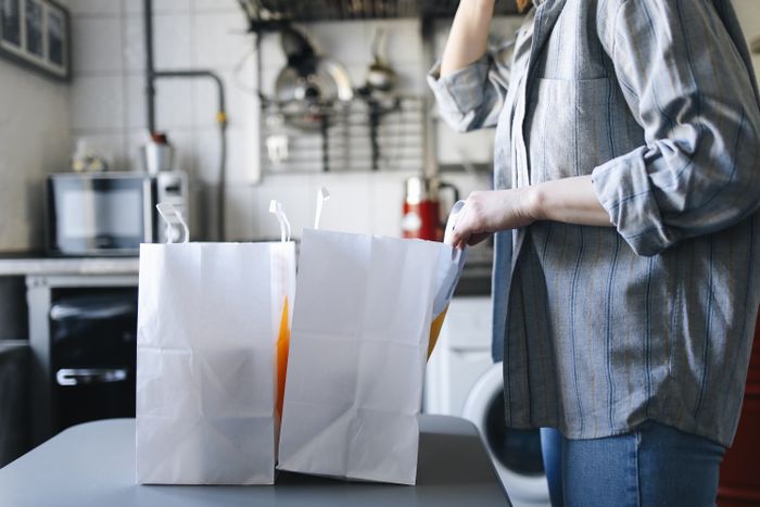 Takeout paper bags on a kitchen counter
