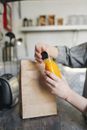 Person Holding Yellow and Black Bottle