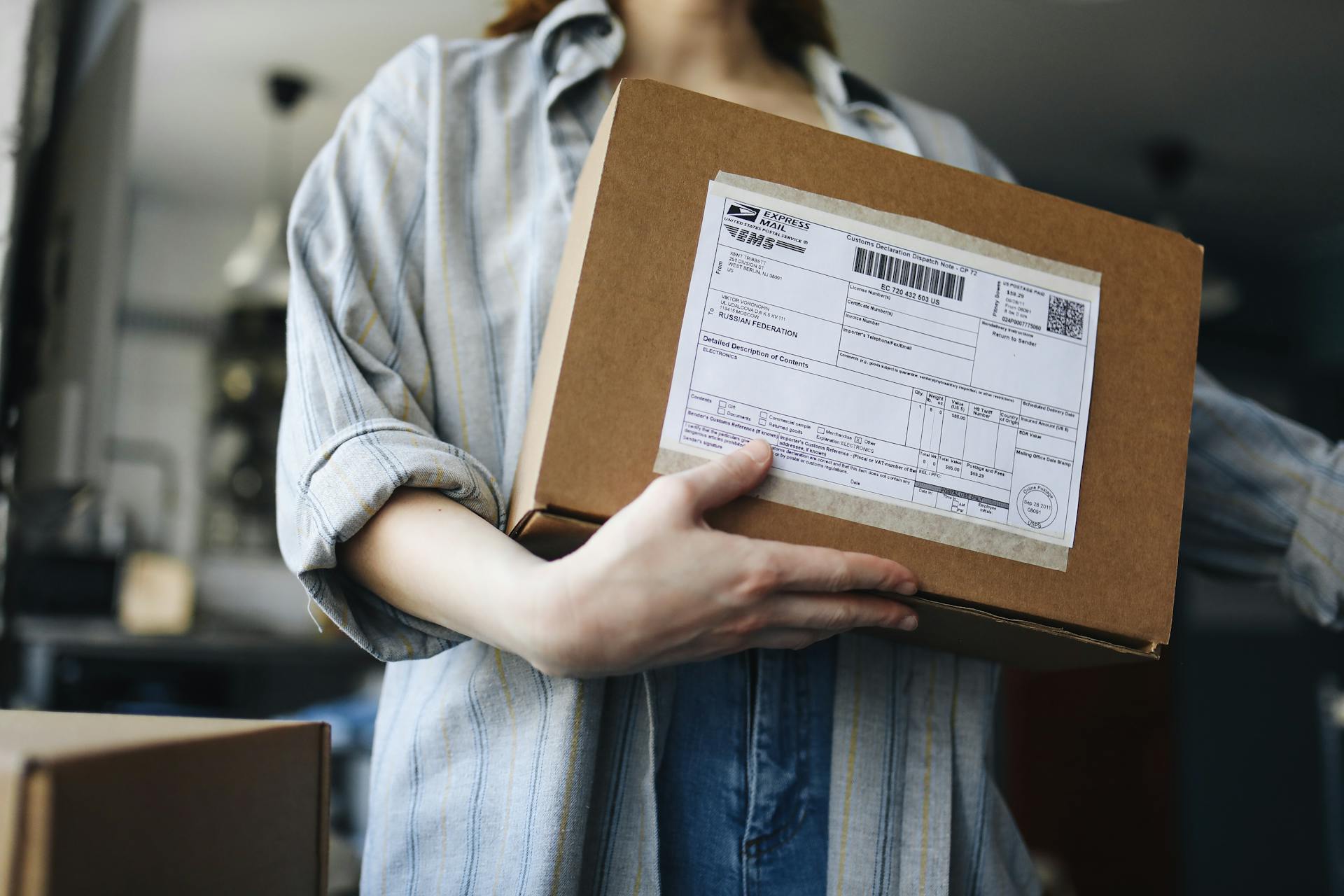 A Person Holding a Delivery Box