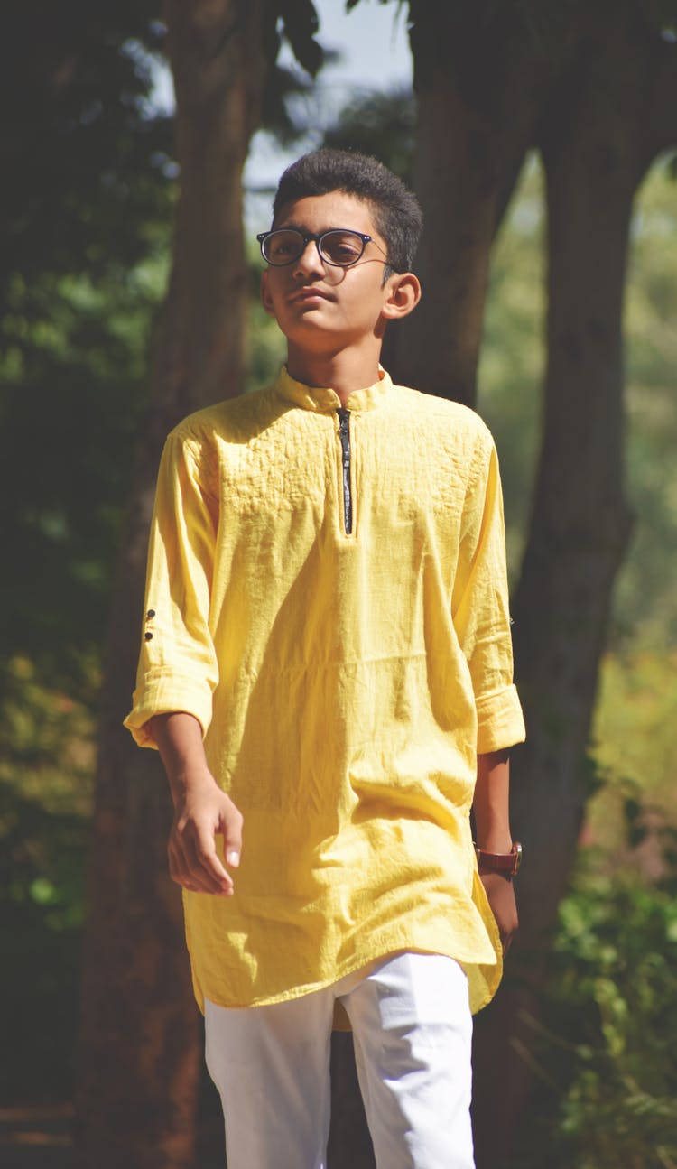 Confident Ethnic Boy Walking In Green Park