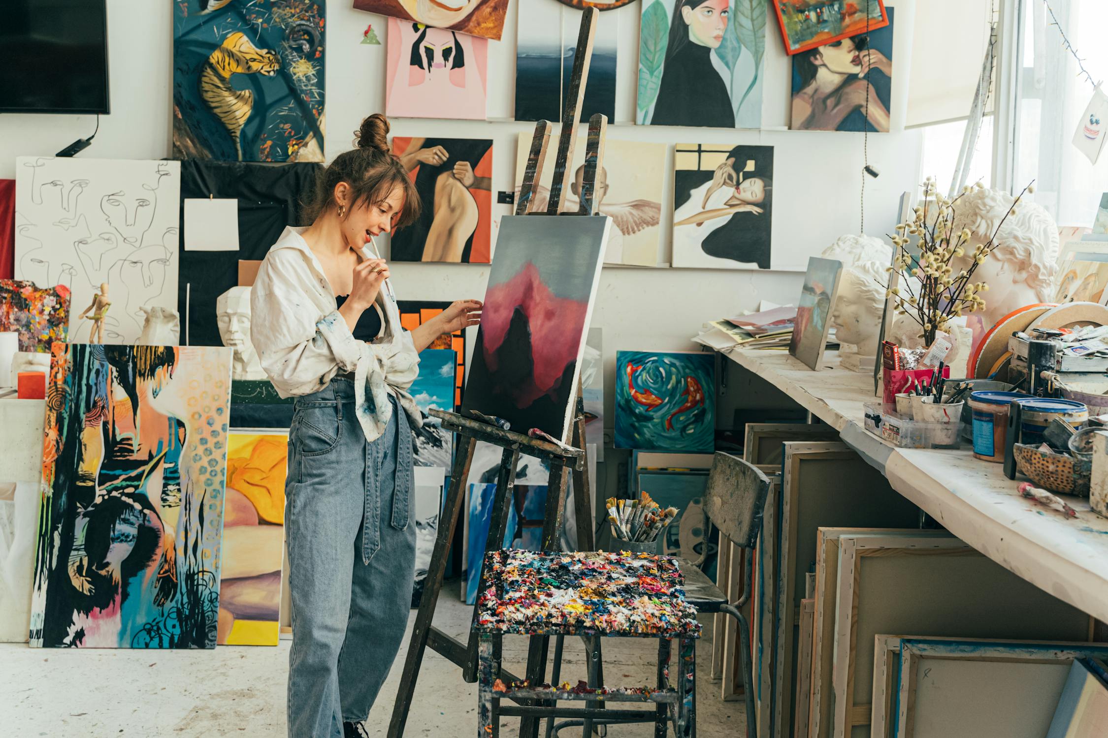 A woman in her studio painting