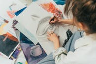 A Woman Making a Drawing on a Sketchpad