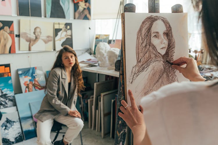 An Artist Drawing A Woman's Portrait