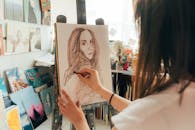 An Artist Drawing on a Canvas