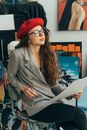 Woman in Brown and White Plaid Coat Wearing Red Hat and Red Cap