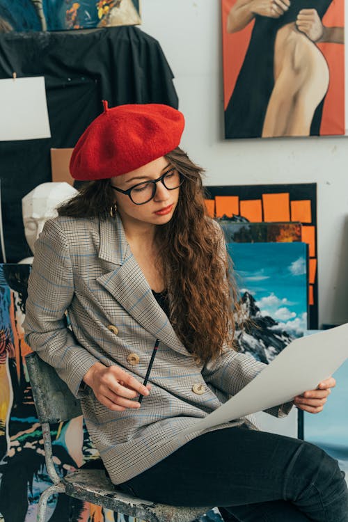 An Artist Holding a Pencil and a Paper 