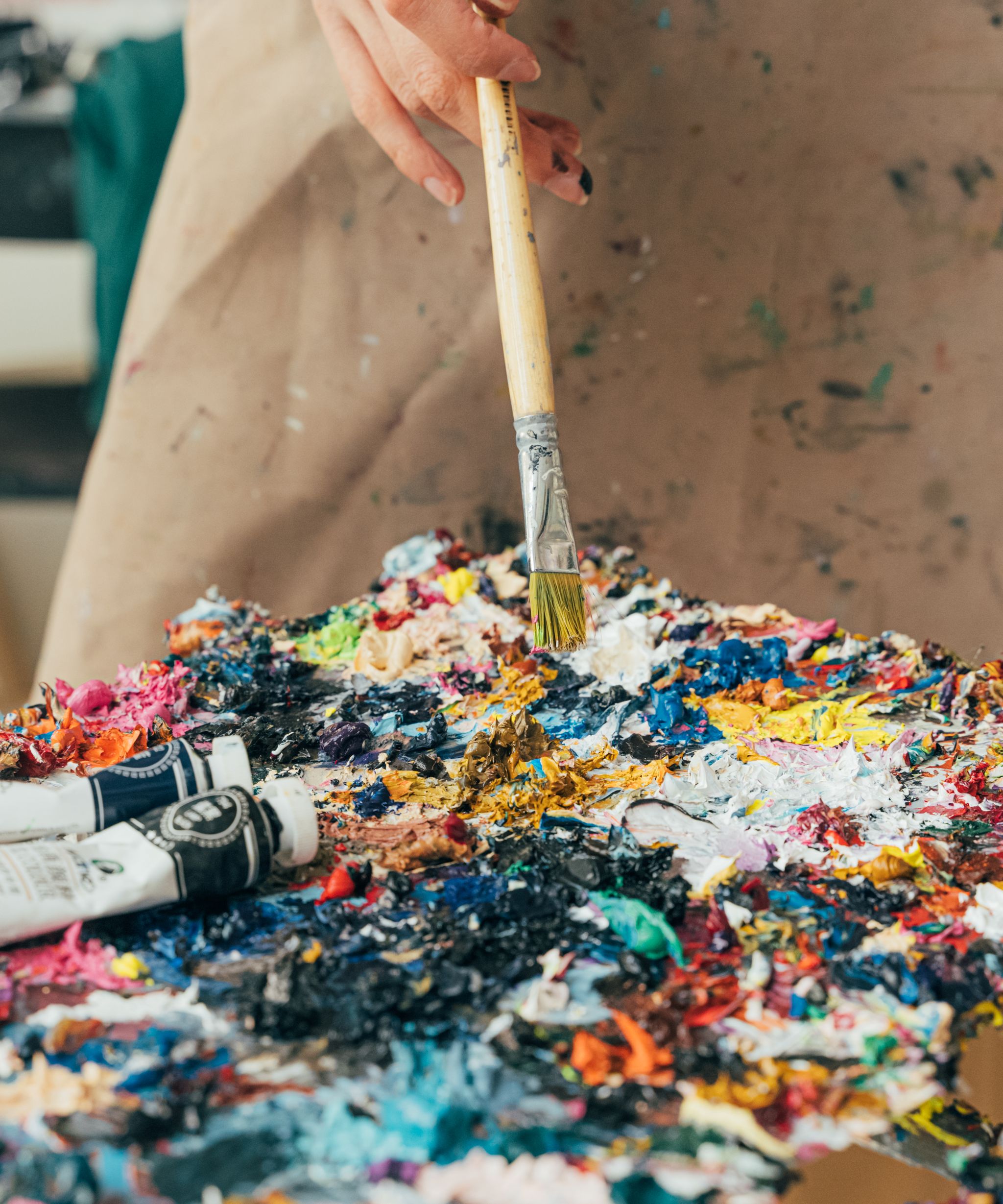 Artist working on a painting in a studio