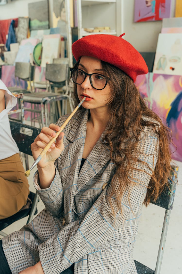 Woman Wearing A Coat Holding A Paintbrush