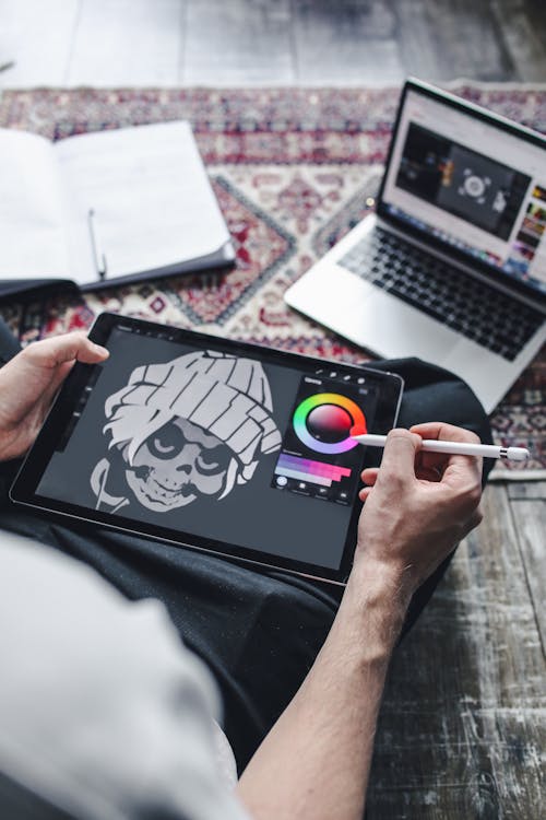 Free A Person Holding a Digital Tablet Stock Photo