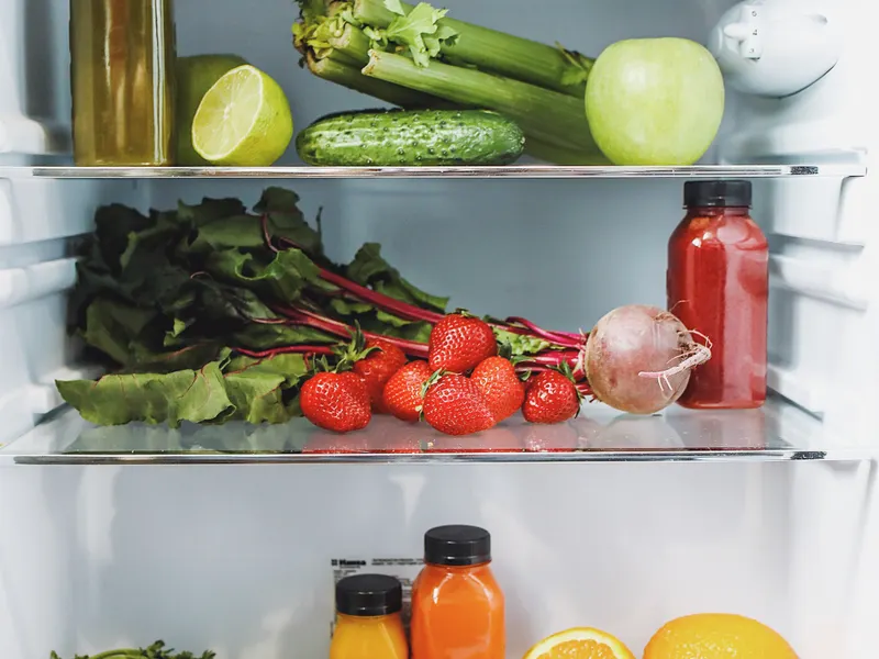 Fresh fruits and vegetables in a refrigerator kept cold by working fan motors Fresh fruits and vegetables in a refrigerator kept cold by working fan motors