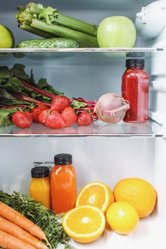Colorful vegetables and juices in a fridge, showcasing healthy and fresh ingredients.