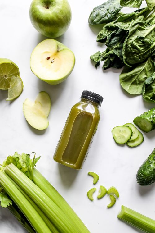 Free Flatlay of fresh green juice with vegetables and fruits on a white background, perfect for healthy lifestyle concepts. Stock Photo