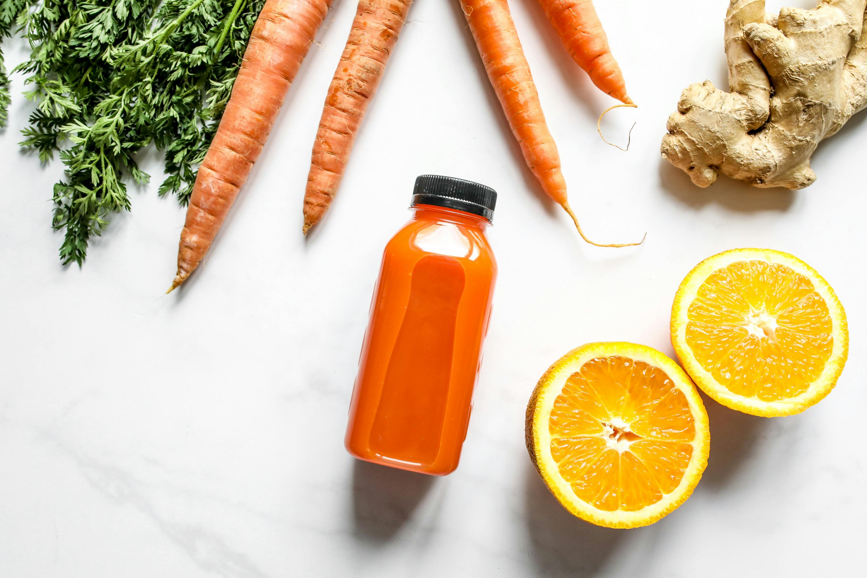 Vibrant carrot and orange juice with ginger, perfect for a nutritious start to the day.