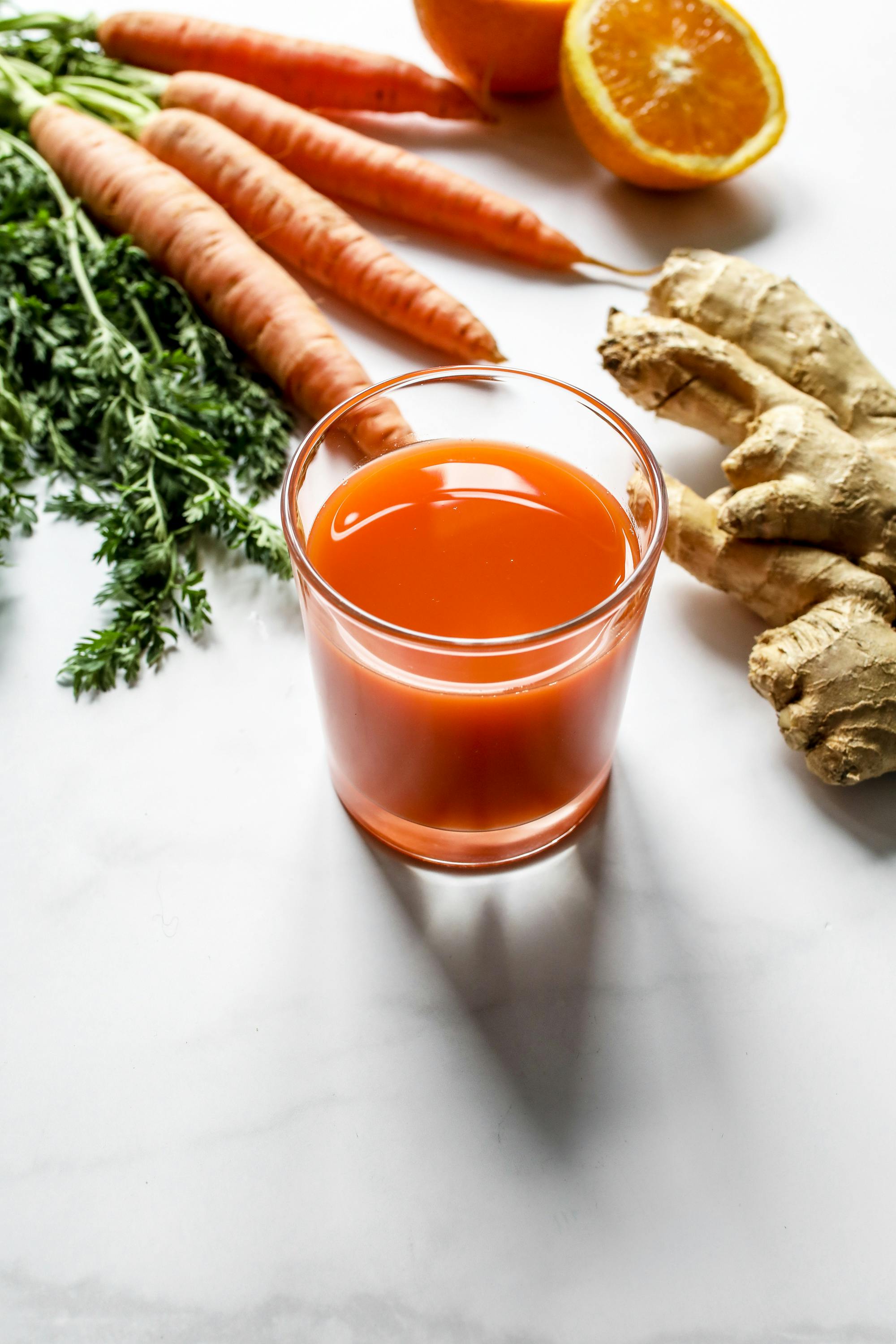 clear drinking glass with orange liquid