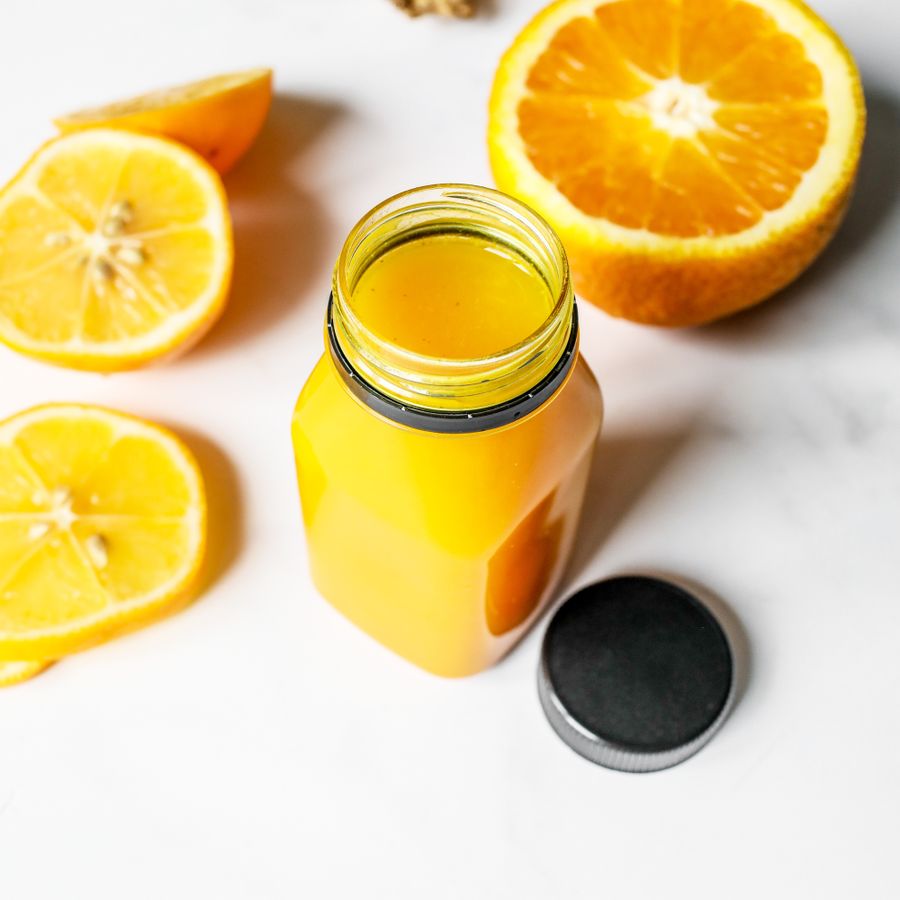 Fresh juice in a jar with sliced oranges