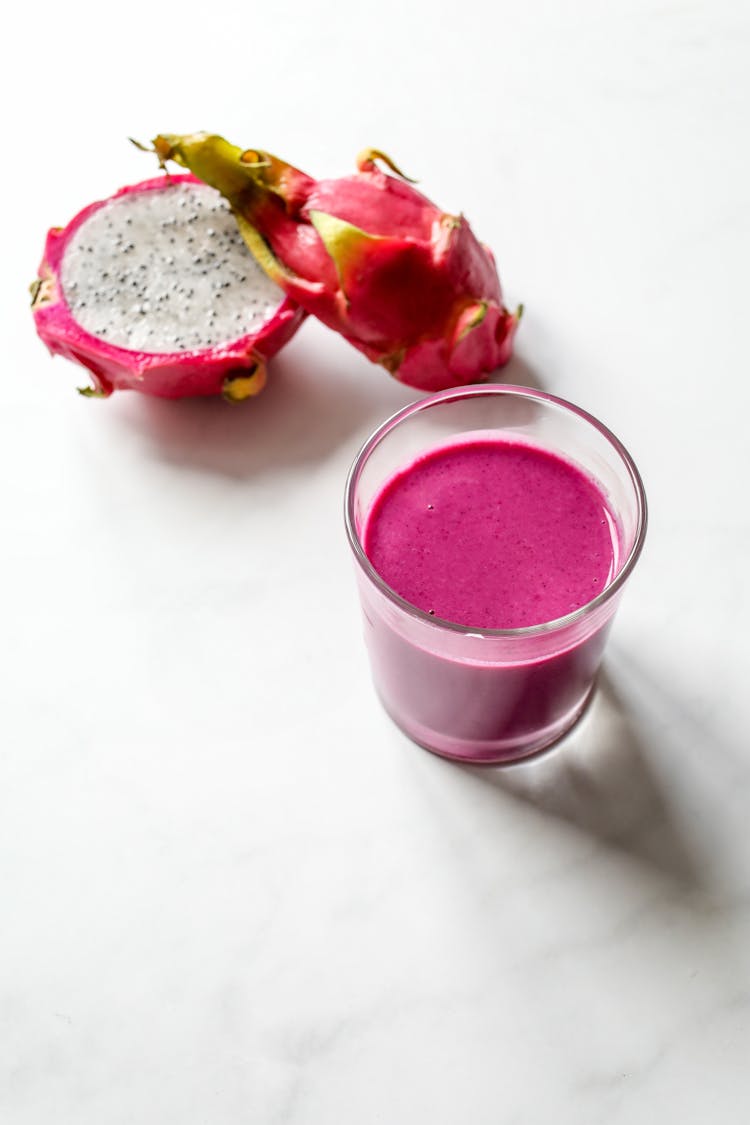 Pink Smoothie In Glass Beside Dragon Fruit