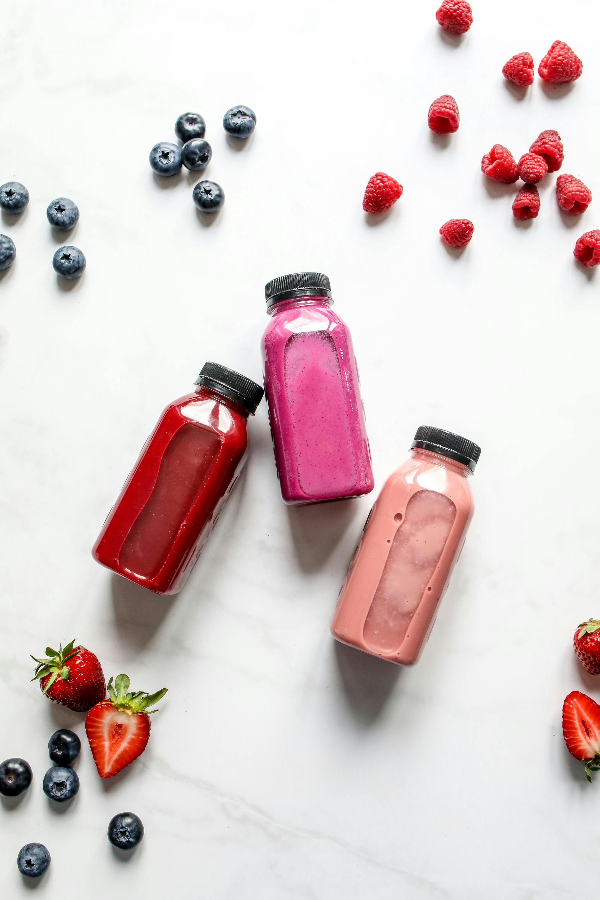 different healthy fruit drinks on plastic bottles