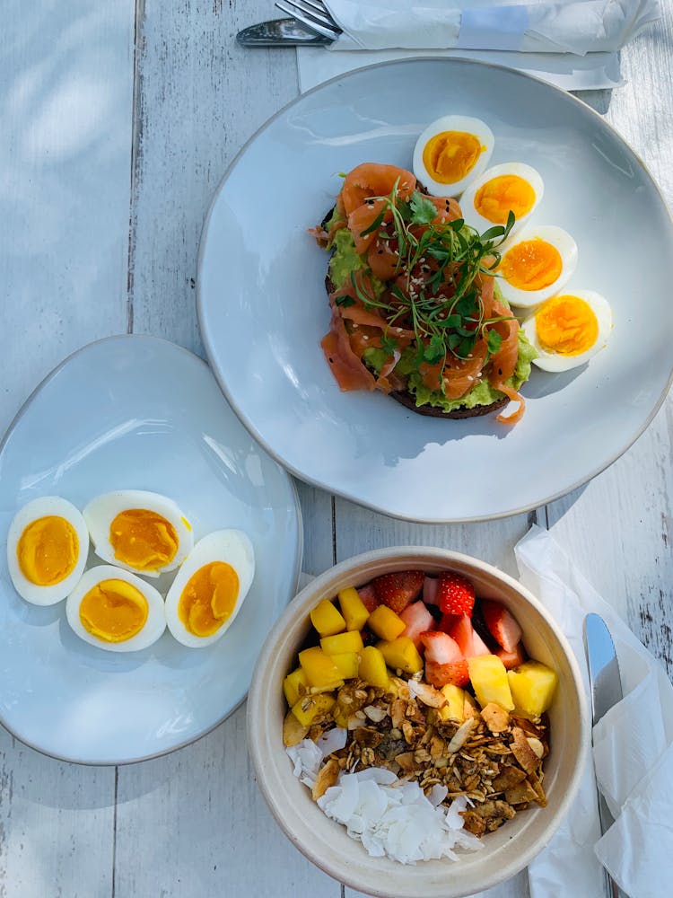 Healthy Breakfast With Boiled Eggs Sandwich And Sliced Fruits