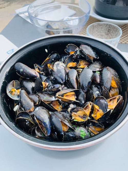 Big bowl with mussels on table