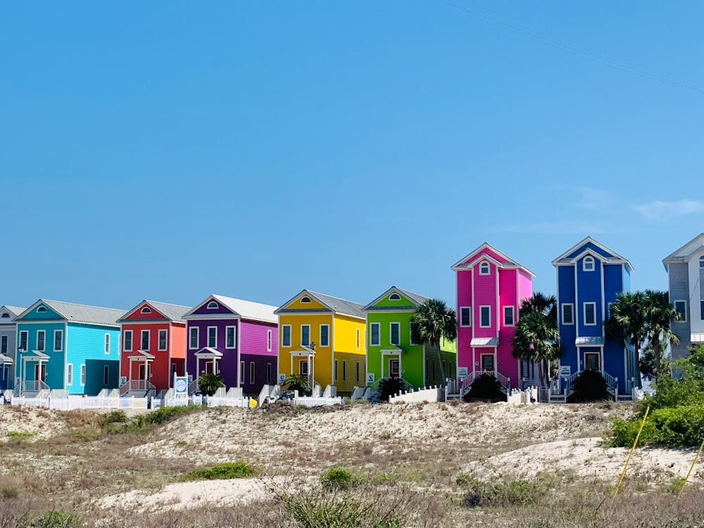 Bright multicolored beachfront houses on hilly terrain · Free Stock Photo