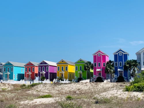 Bright multicolored beachfront houses on hilly terrain