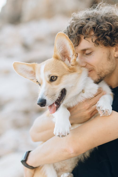 Free A Man Carrying His Dog Stock Photo