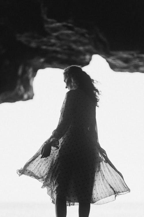 A Grayscale Photo of a Woman Wearing a Polka Dot Dress