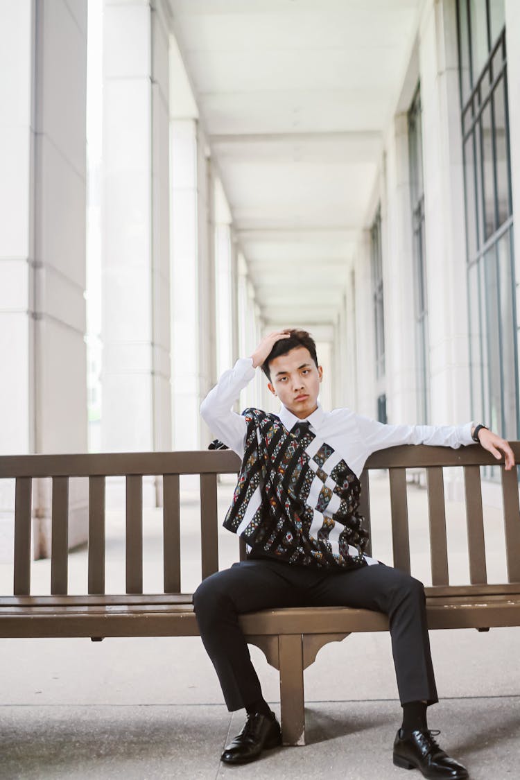 Photo Of Man Wearing White Dress Shirt While Sitting On Wooden Bench