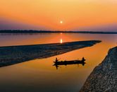 Fishermen in boat in calm river