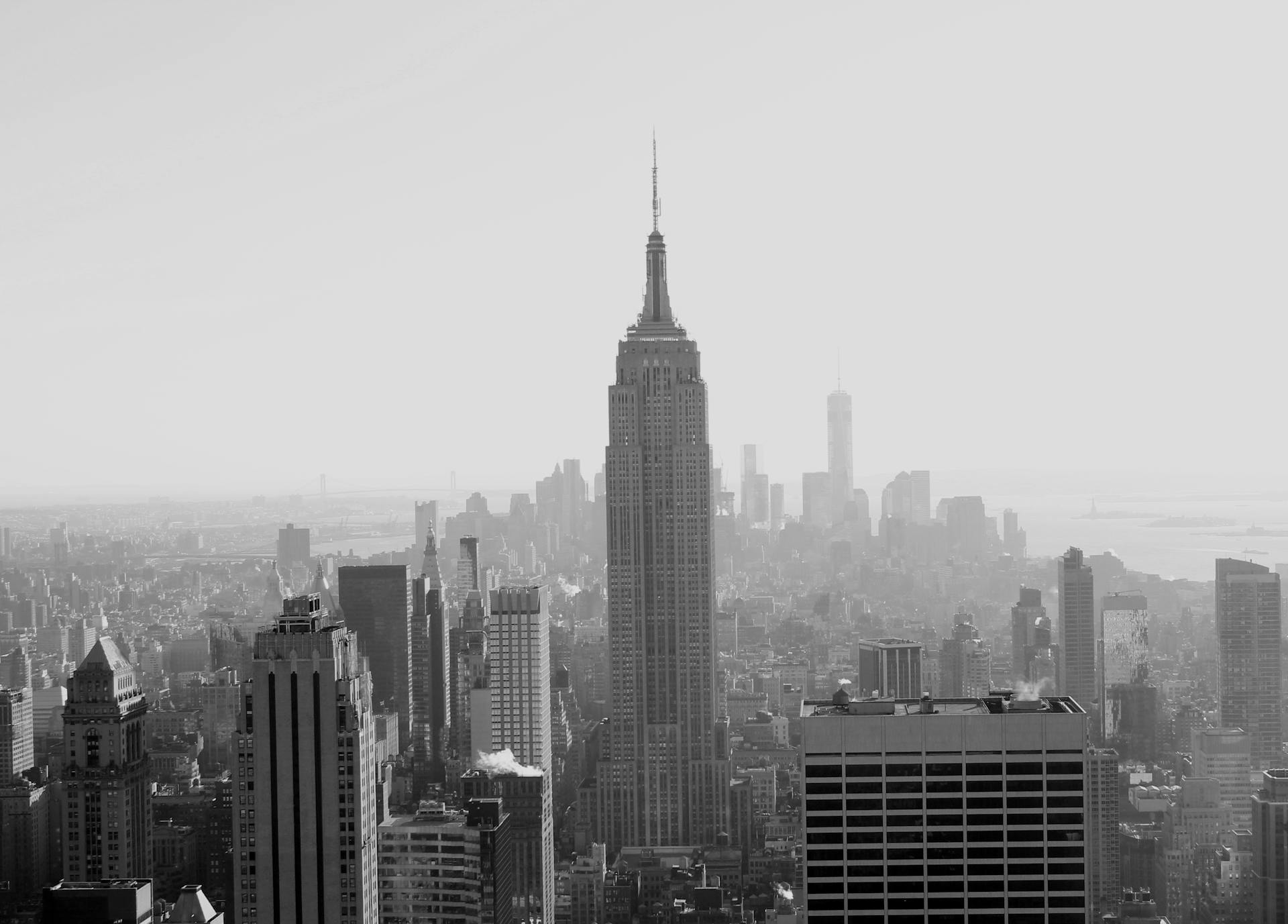 Monochrome photo of New York City's skyline featuring the Empire State Building towering over downtown.
